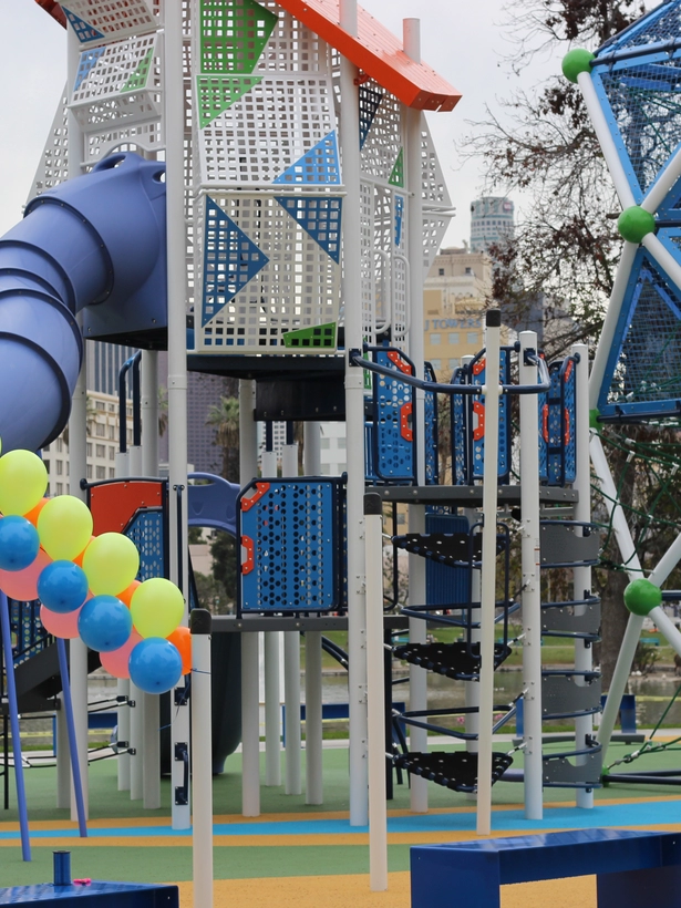 A playground with a slide and climbing structure. 